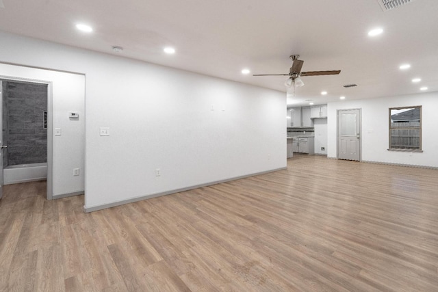 unfurnished living room featuring ceiling fan and light hardwood / wood-style floors