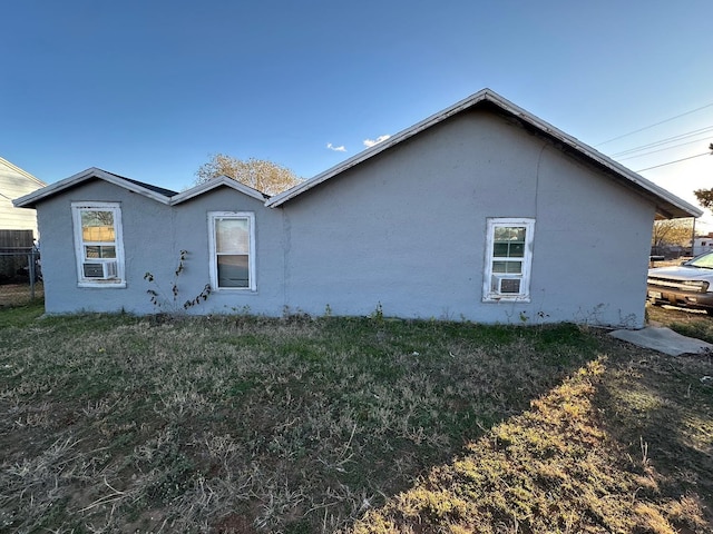 view of property exterior with a lawn