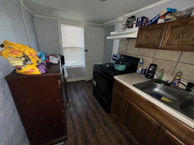 kitchen with dark hardwood / wood-style floors, sink, decorative backsplash, dark brown cabinets, and black / electric stove