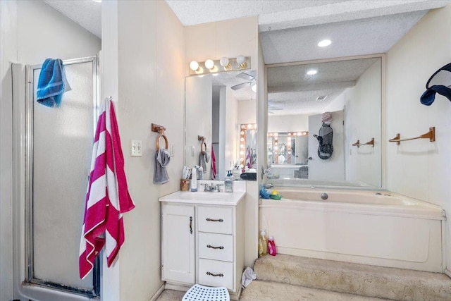 bathroom with a shower with door, vanity, and a textured ceiling