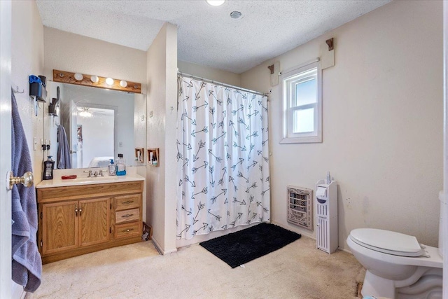 bathroom featuring heating unit, vanity, a textured ceiling, toilet, and walk in shower