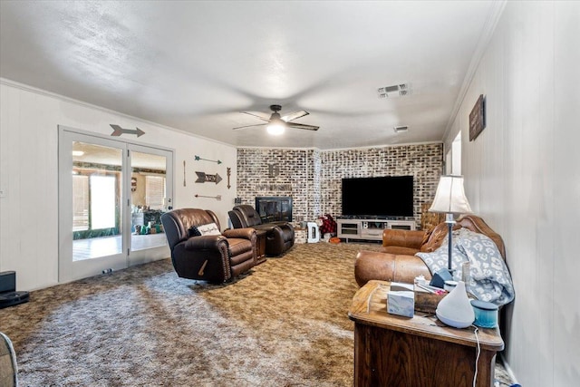 living room featuring ornamental molding, ceiling fan, and carpet flooring