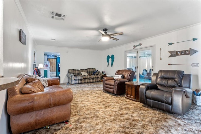 carpeted living room with ornamental molding and ceiling fan