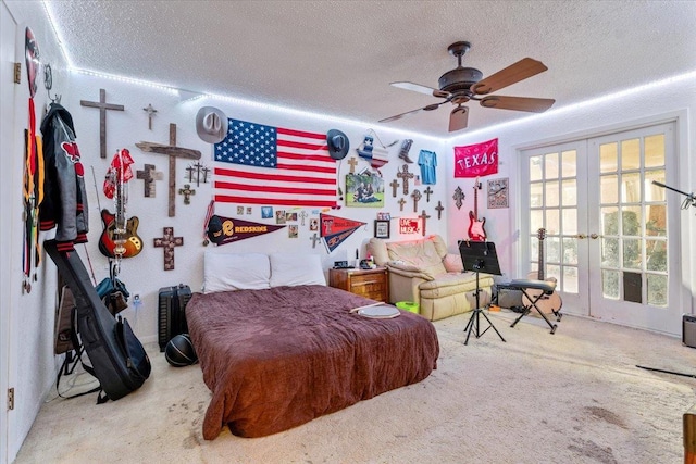 carpeted bedroom with ceiling fan, a textured ceiling, and french doors