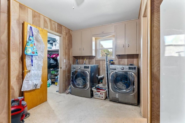 laundry area featuring cabinets, washing machine and dryer, and light carpet