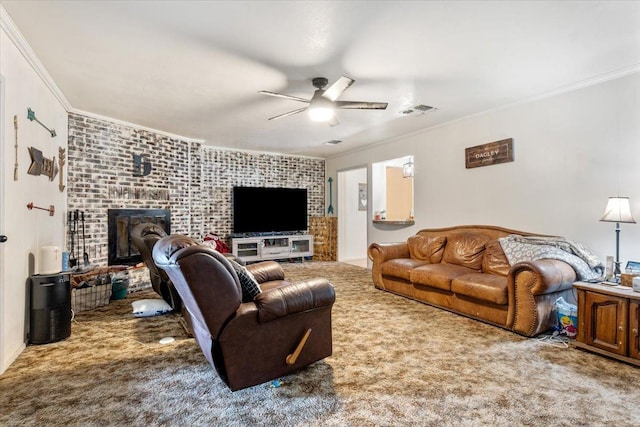 living room featuring ornamental molding, a brick fireplace, carpet floors, and ceiling fan