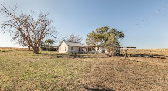 view of yard with a rural view and a pergola