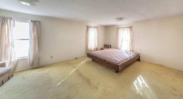 carpeted bedroom featuring a textured ceiling