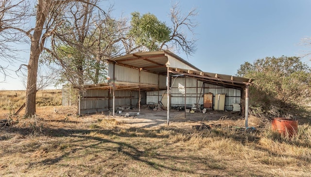 back of property featuring an outdoor structure