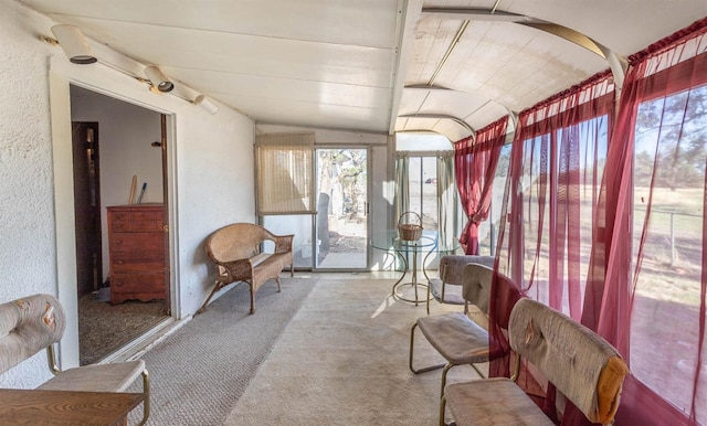 sunroom / solarium featuring lofted ceiling