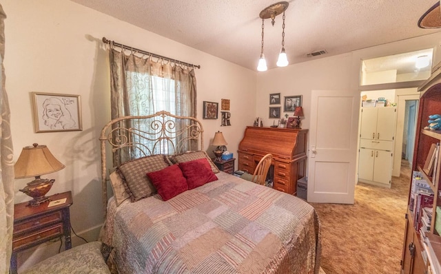 bedroom featuring light carpet and a textured ceiling