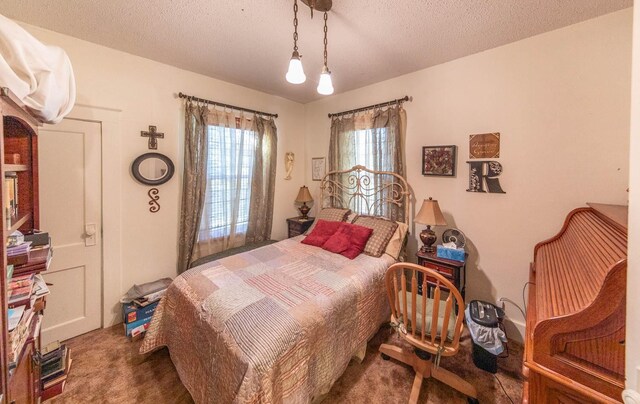 carpeted bedroom featuring a textured ceiling