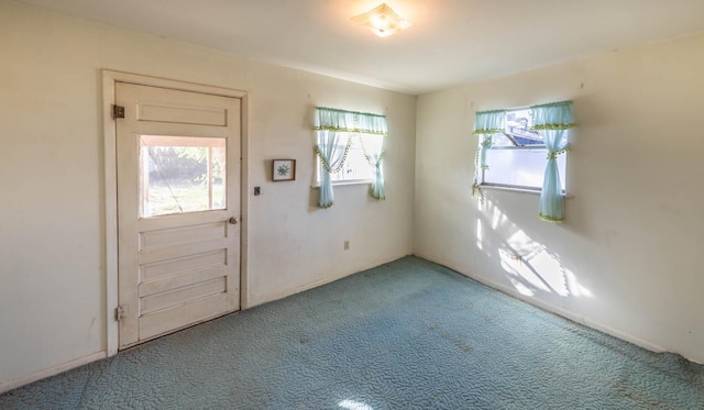 foyer entrance featuring carpet flooring