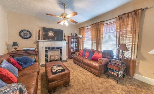 carpeted living room with ceiling fan, a fireplace, and a textured ceiling