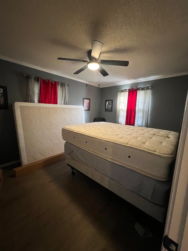 bedroom featuring crown molding, ceiling fan, and a textured ceiling