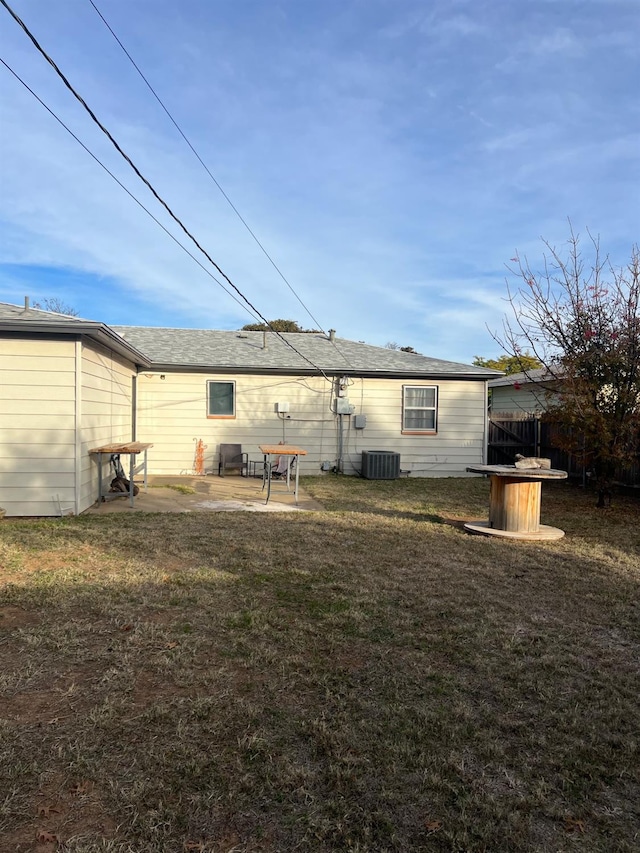back of house with central AC, a yard, and a patio area
