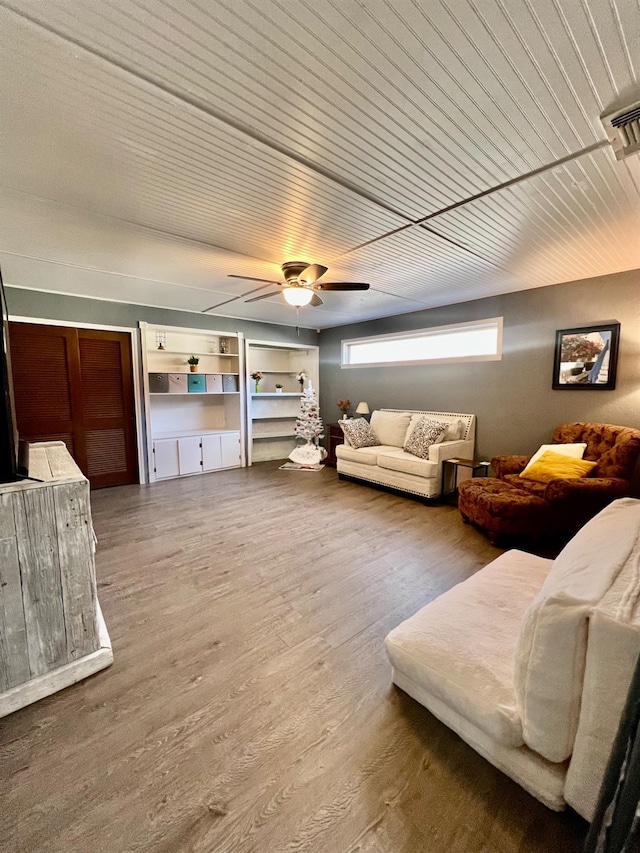 living room featuring wood ceiling, hardwood / wood-style flooring, and ceiling fan