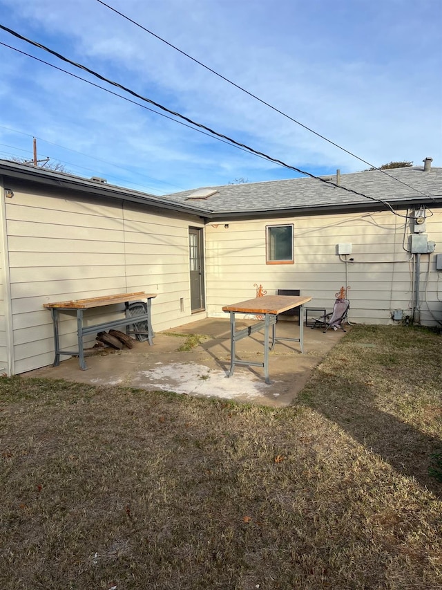 back of house featuring a yard and a patio area