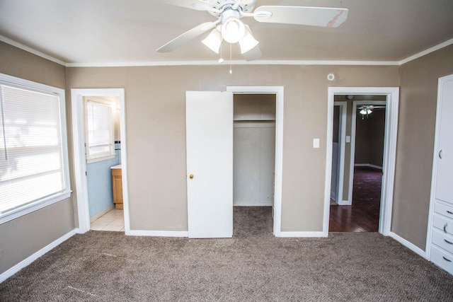 unfurnished bedroom with crown molding, a closet, and light carpet