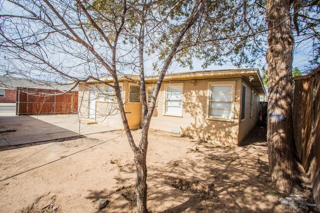 view of side of property with a patio