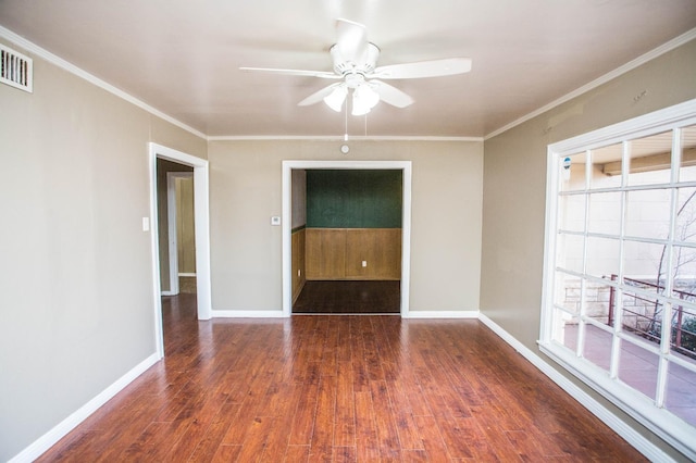 unfurnished room with crown molding, dark hardwood / wood-style floors, and ceiling fan