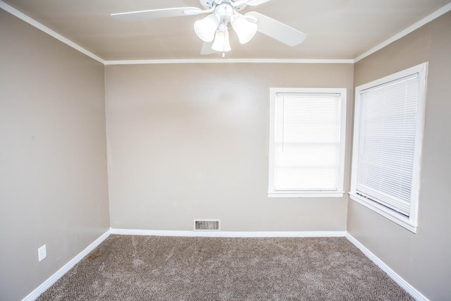 carpeted empty room with ceiling fan and ornamental molding