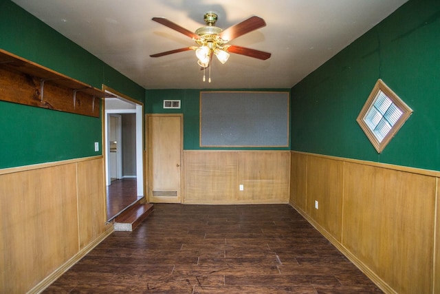 empty room with ceiling fan and dark hardwood / wood-style flooring