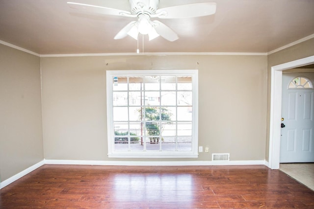 spare room with crown molding, dark hardwood / wood-style floors, and ceiling fan