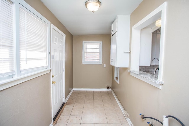 laundry area featuring light tile patterned flooring