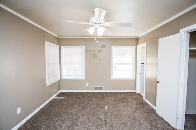 carpeted spare room with crown molding and ceiling fan