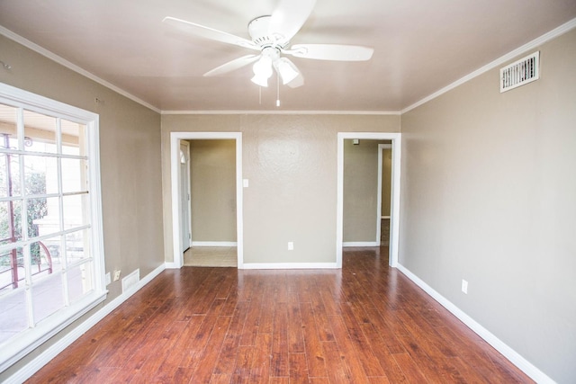 unfurnished room with dark hardwood / wood-style flooring, ornamental molding, and ceiling fan