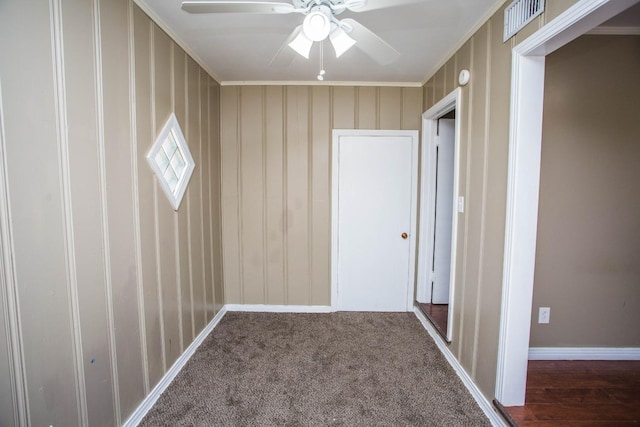 interior space with dark colored carpet and crown molding