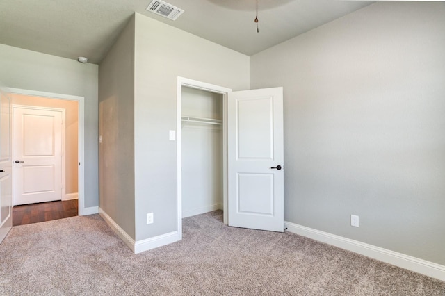 unfurnished bedroom featuring carpet and a closet