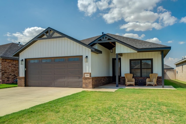 view of front of home featuring a garage and a front lawn