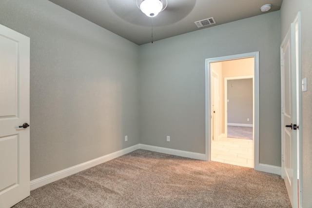 empty room featuring ceiling fan and carpet floors