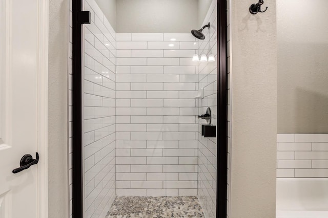 bathroom featuring a shower with door