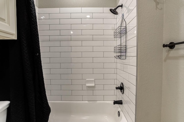 bathroom with shower / bathtub combination with curtain and toilet