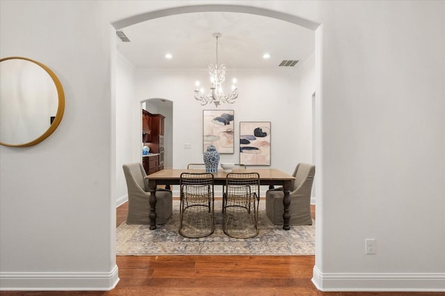 dining room featuring an inviting chandelier and wood-type flooring