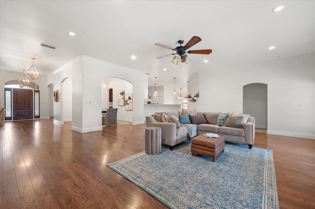 living room with hardwood / wood-style flooring, ornamental molding, and ceiling fan