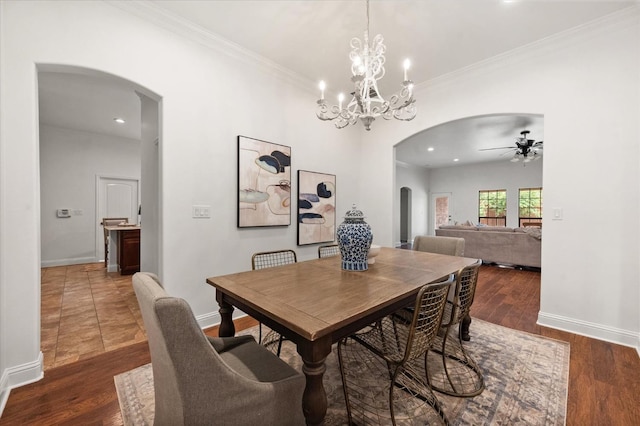 dining space featuring dark hardwood / wood-style flooring, crown molding, and ceiling fan