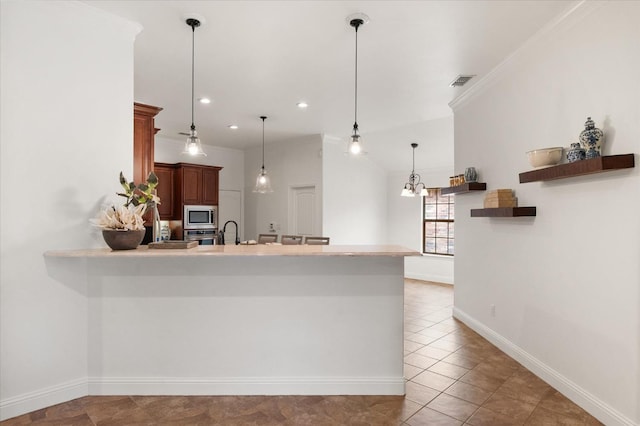 kitchen with stainless steel appliances, pendant lighting, a kitchen bar, and kitchen peninsula