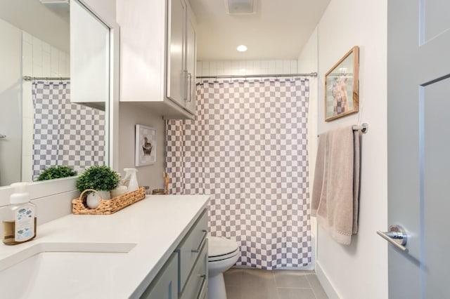 bathroom featuring vanity, toilet, and tile patterned flooring