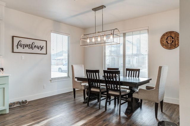 dining room featuring dark hardwood / wood-style floors and a chandelier