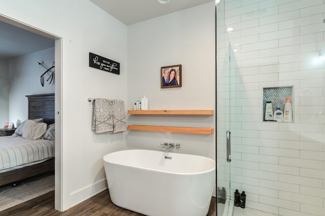 bathroom with wood-type flooring and independent shower and bath