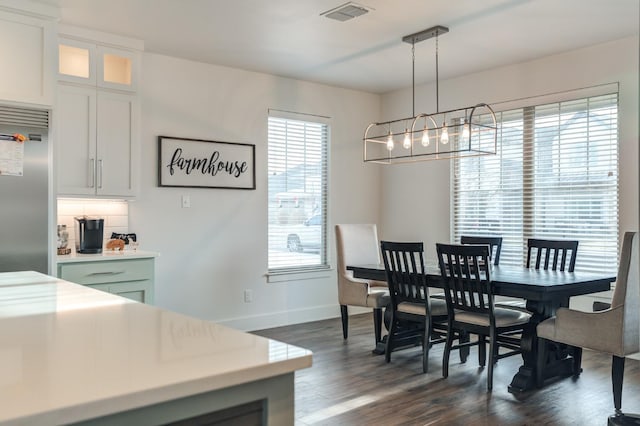 dining room featuring an inviting chandelier and dark hardwood / wood-style floors