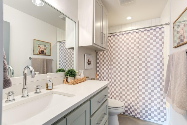 bathroom featuring walk in shower, vanity, and toilet