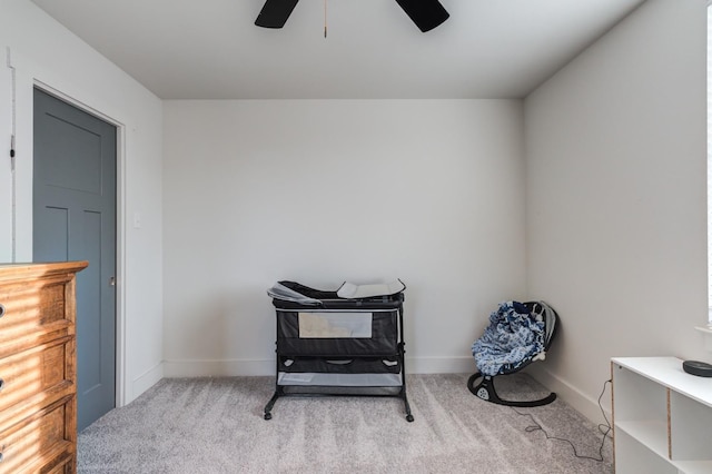 living area featuring ceiling fan and light colored carpet