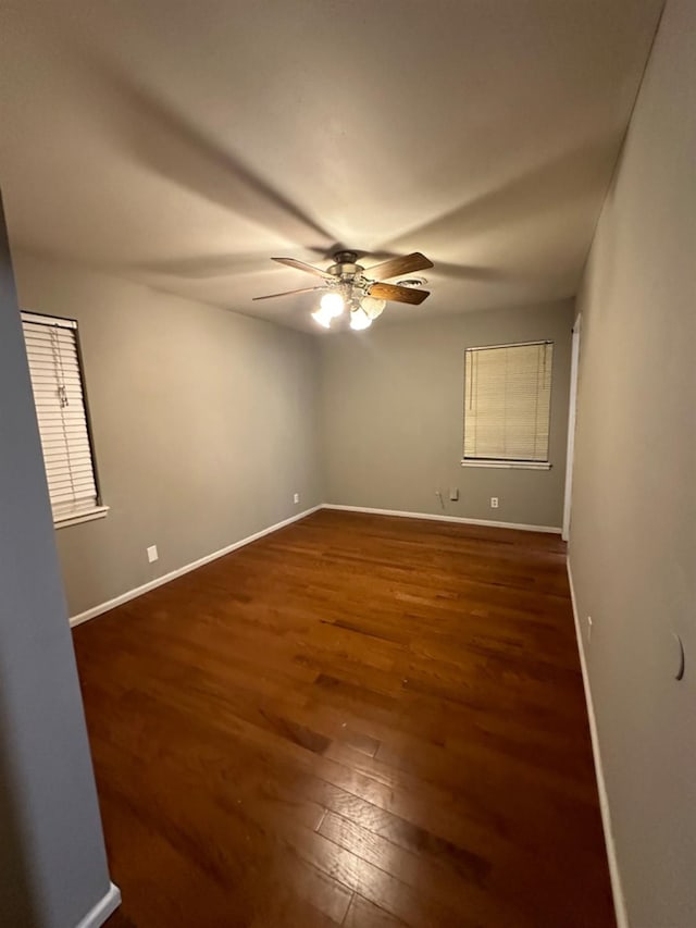 unfurnished room featuring ceiling fan and dark hardwood / wood-style flooring