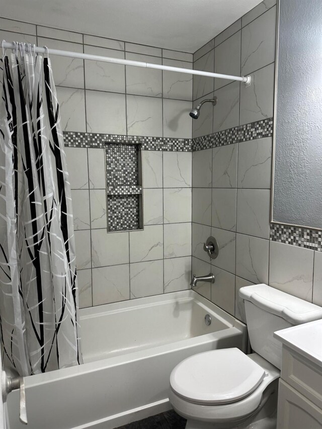 full bathroom featuring shower / tub combo, vanity, tile walls, and toilet