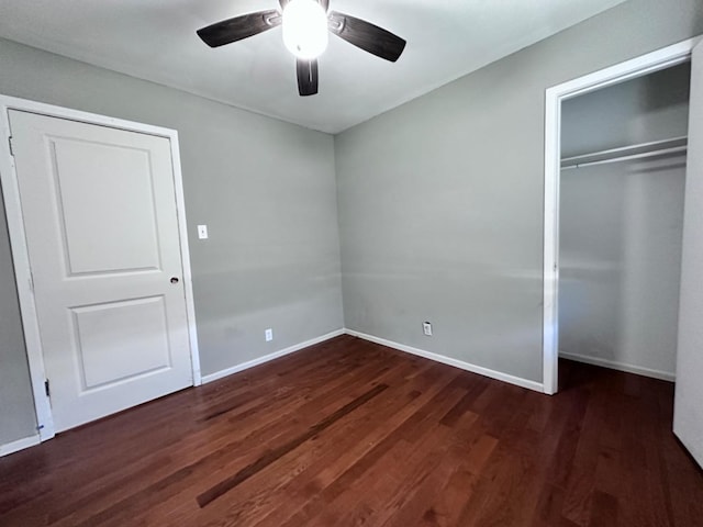 unfurnished bedroom featuring ceiling fan, dark hardwood / wood-style floors, and a closet